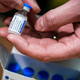 j&j vaccine vial in hands